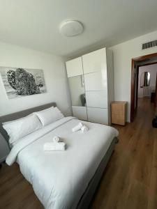 um quarto com uma cama branca com duas toalhas em Queen Caesarea Suite em Caesarea