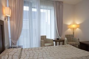 Postel nebo postele na pokoji v ubytování Hotel Burgas