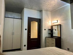 a bedroom with a bed and a dresser and a mirror at Hotel Silver in Sozopol