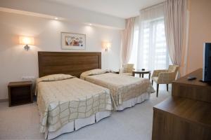 Postel nebo postele na pokoji v ubytování Hotel Burgas