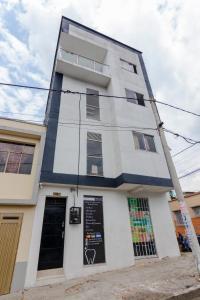 a tall white building with a sign on it at Moderno loft en el centro de Pereira in Pereira
