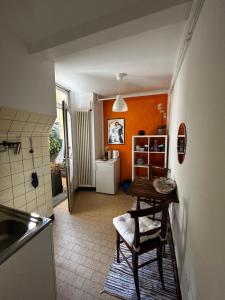 a small kitchen with a table and a refrigerator at Charming Room in the heart of Locarno in Locarno