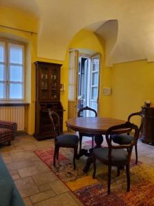 a dining room with a wooden table and chairs at Gallina Apartment in Bra