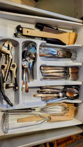a drawer filled with silver utensils in a drawer at Apartament Bystra Woda 28 z garażem in Zakopane