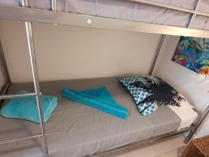 a bed in a bunk bed with two pillows at appartement KER-EOL Sainte-Anne avec piscine in Sainte-Anne