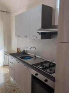 a kitchen with a sink and a stove top oven at Casa del Corso Ribera in Ribera