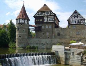 a castle with two towers and a waterfall at Ferienwohnung Moments klimatisiert in Balingen