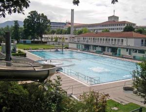 a large swimming pool in front of a building at Ferienwohnung Moments klimatisiert in Balingen