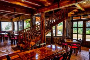 a dining room with tables and chairs and a staircase at Hacienda Turistica Intihuatana in San Fernando