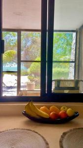 a plate of fruit on a counter in front of a window at Beachfront apartment with swimming pool. One bedroom in Celestún