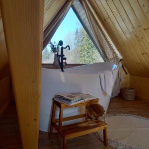 a bath tub in a tent with a window at Babcia Góralka house in Bukowina Tatrzańska