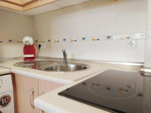 a kitchen with a sink and a counter top at Apartamento Bahía Levante II Águilas in Águilas +19 photos