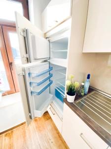 a refrigerator with the door open in a kitchen at 666 Plagwitz Apartment Kulturviertel in Leipzig