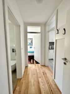 a white room with a hallway with a bathroom at Lux Apartments Minja in Pale