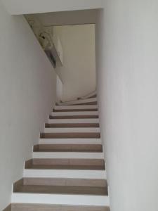a staircase in a building with a stair case at Casa al Corso Sant'Antioco (SU) in SantʼAntìoco