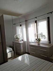 a bedroom with a large mirror and a dresser at Casa al Corso Sant'Antioco (SU) in SantʼAntìoco