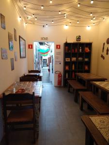 a restaurant with wooden tables and benches in a room at Hospedaria da Mama in São Paulo