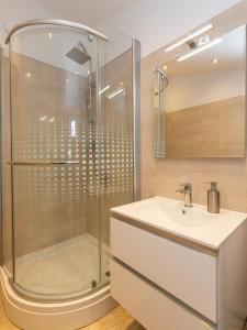 a bathroom with a sink and a shower at Apartments Ana in Biograd na Moru