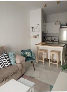 a living room with a couch and a kitchen at Zaharaiso luz in Zahara de los Atunes
