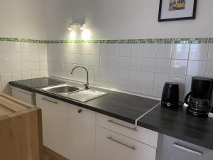 a kitchen with a sink and a counter top at Appartement le Paul Bert Auxerre Les Quais 2 personnes in Auxerre