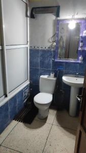 a bathroom with a toilet and a sink at Appartement Fes très propre et calme in Fez