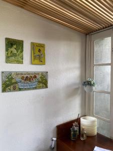een kamer met drie foto's aan de muur en een tafel bij Chez nous in Petrópolis