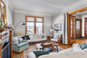 a living room with a couch and a table at Dubuque's Front Porch, Historic Charmer, Walk Downtown in Dubuque