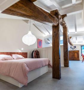 a bedroom with a large bed and wooden beams at Apartamentos en Baztan HIRU KABI, BIGA 