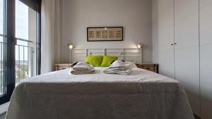 Un dormitorio con una cama con almohadas verdes. en Kiana Mirador Jerez con parking, en Jerez de la Frontera