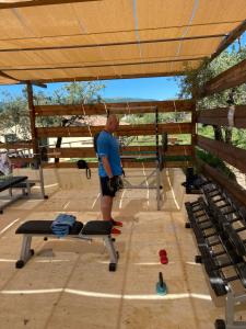 a man standing in a gym with a machine at Agriturismo AgrileisureTime in Spoleto