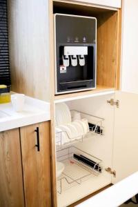 a kitchen with a microwave oven in a cabinet at Tanjung Jara Cottage - with indoor pool in Dungun