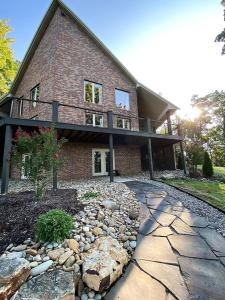 a brick house with a stone walkway in front of it at Pointe View Lodge 