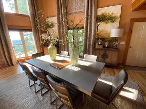 a dining room table with chairs and vases on it at Pointe View Lodge 