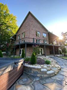 a large brick house with a stone path in front of it at Pointe View Lodge 