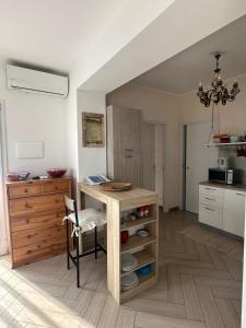 a kitchen with a table and a chair in a room at Casa del sasso in Bergeggi