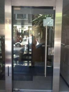 a reflection of a person in a glass door at Departamento Centrico Mar del Plata, 2 ambientes in Mar del Plata