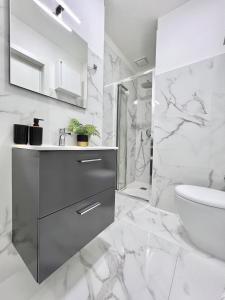 a white bathroom with a sink and a toilet at Corso Venezia in Mestre