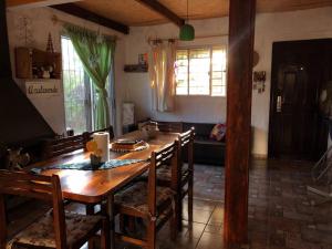 a dining room with a wooden table and chairs at Hermoso lugar de descanso en Santa Ana a una cuadra de la playa in Araminda