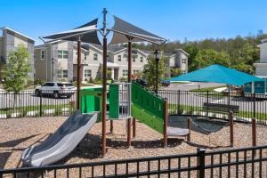a playground with a slide and an umbrella at Luxury 9BR Villa @ Storey Lake Resort Near Disney in Kissimmee