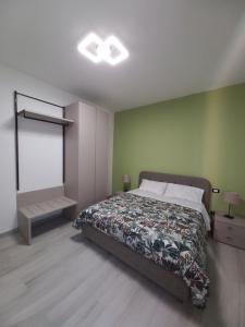 a bedroom with a bed and a green wall at L.ADY HOME in Bologna