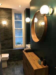 a bathroom with a sink and a mirror on the wall at Centrally Located London Apartment in London