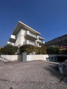 a large apartment building with a driveway in front of it at Garden & Pool Perugini in Nago-Torbole