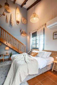 a bedroom with a bed and a surfboard on the wall at Dolphin Village - Sea Resort By Ran Hotels in Shave Ẕiyyon