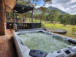 a hot tub on the deck of a house at Redgate Homestead in Hartley