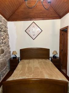 a bedroom with a large bed with two night stands at Casa Padre Alexandre in Covide