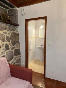 a bathroom with a walk in shower and a sink at Casa Padre Alexandre in Covide