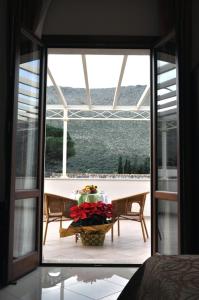 a view of a room with a table and a glass door at Dolce Siesta in Castelluzzo