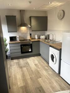 a kitchen with a washer and dryer in it at Priestley Apartments Ap 2 in Nantwich