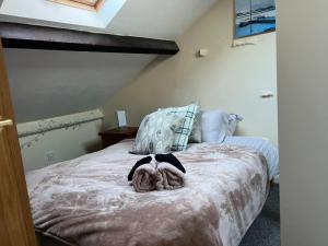 a bedroom with a bed with two stuffed animals on it at Arnside sea view in Arnside