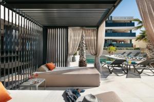 een woonkamer met een bed en een patio bij Malibu Imperial Resort in Vir